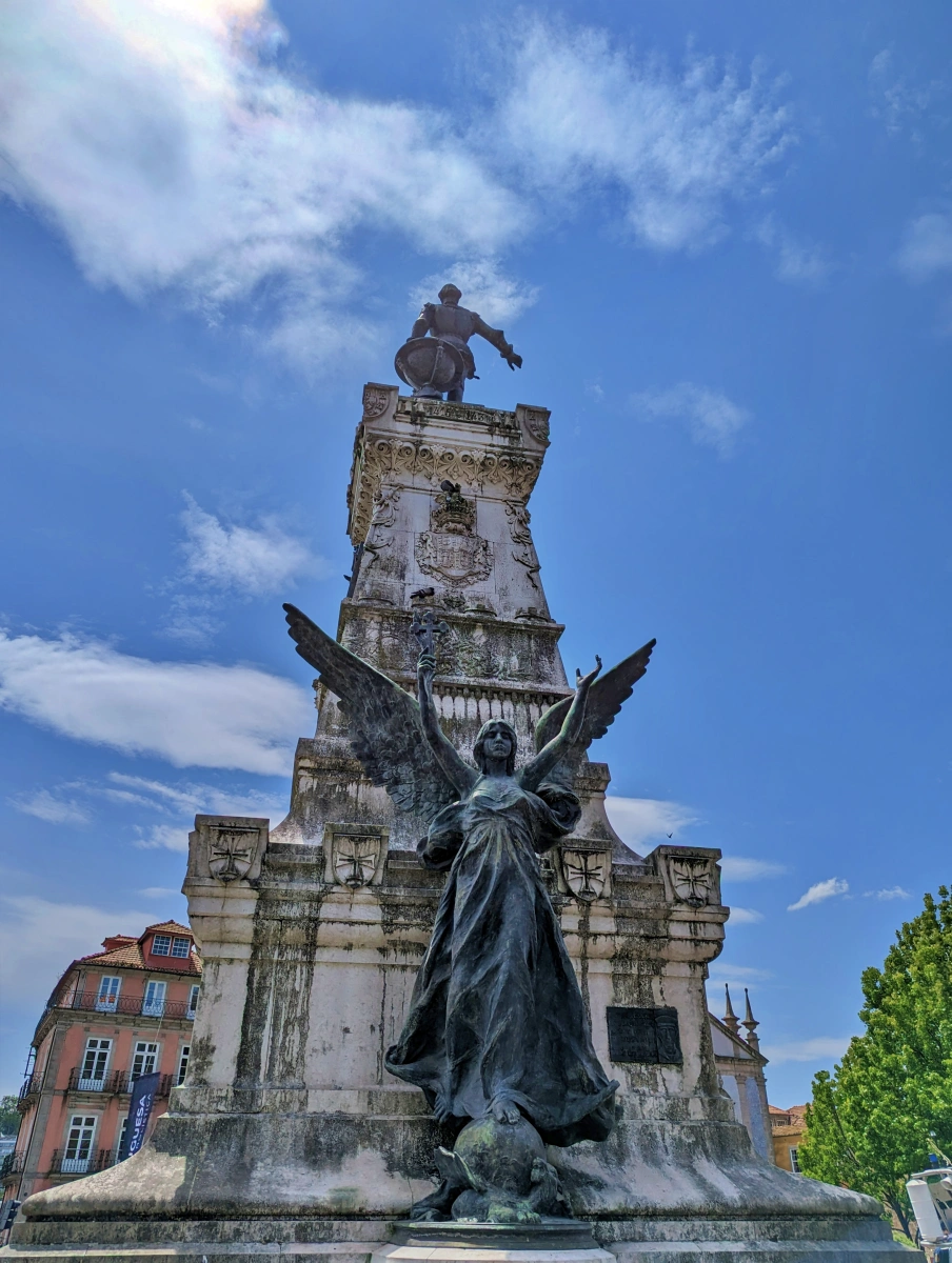 Monumento con estatua del Infante Dom Henrique señalando al horizonte y figura alada en la base